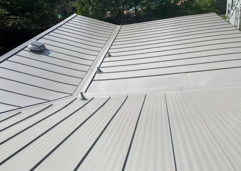 Solar attic fan installed on a metal roof for Roof Ventilation in Trinidad